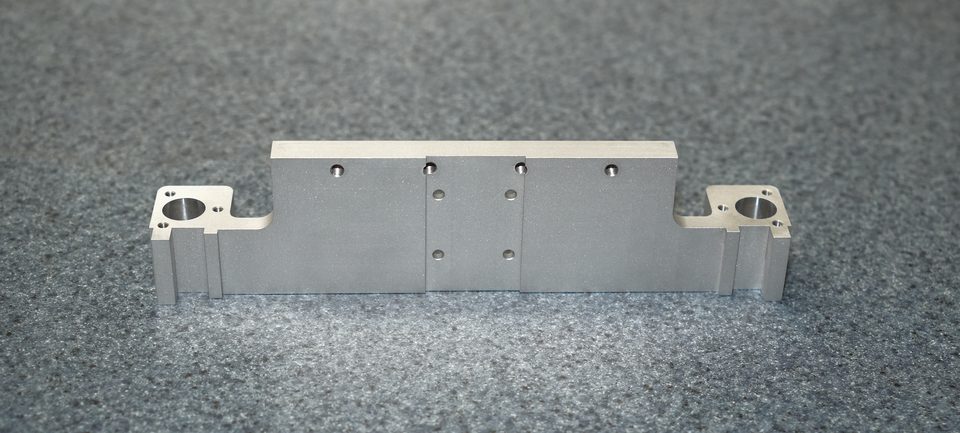 Silver machined bracket with precision holes
